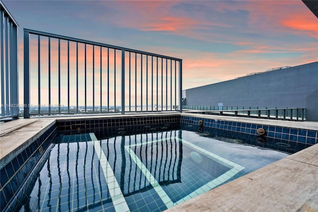 view of pool at dusk