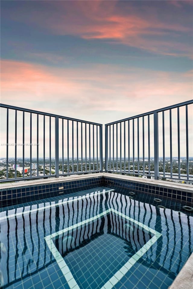 view of pool at dusk