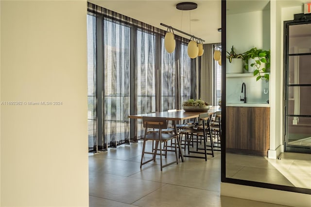 dining space with a wall of windows and concrete floors