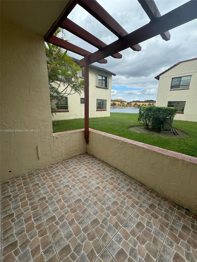 view of patio / terrace featuring a water view and a pergola