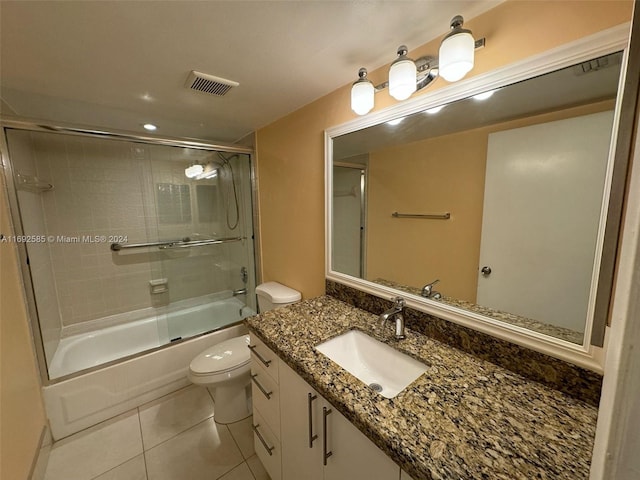 full bathroom with tile patterned flooring, vanity, toilet, and enclosed tub / shower combo