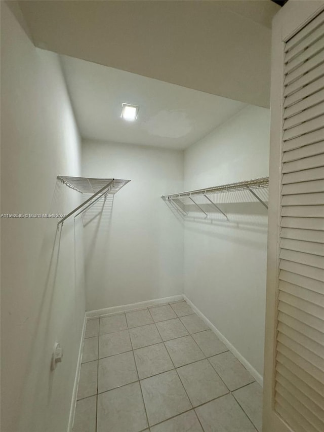 walk in closet featuring light tile patterned flooring