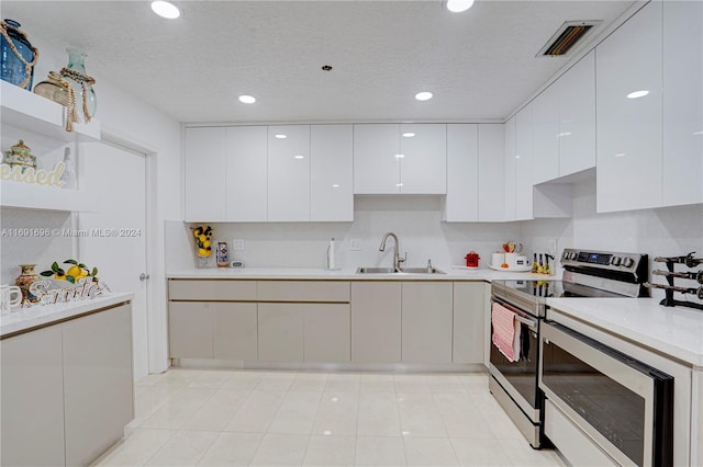 kitchen with white cabinets, a textured ceiling, sink, and stainless steel appliances