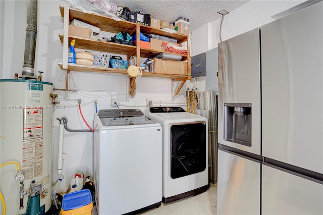 clothes washing area with a textured ceiling, gas water heater, and independent washer and dryer