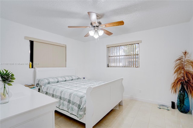 bedroom with a textured ceiling and ceiling fan