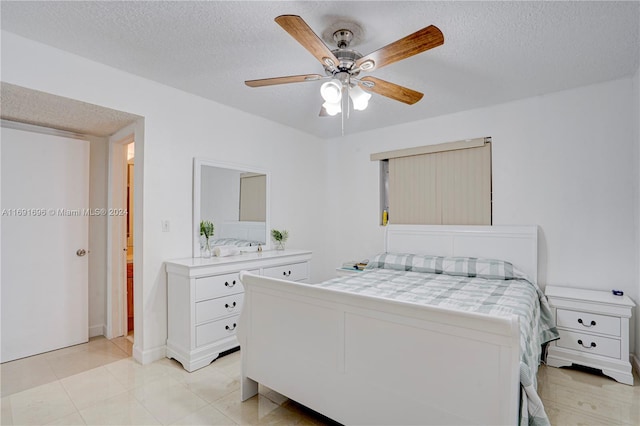 bedroom with a textured ceiling and ceiling fan