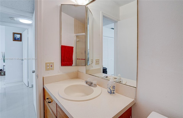 bathroom featuring vanity, tile patterned floors, and a textured ceiling