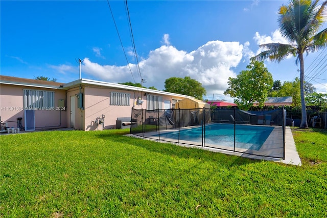 view of pool with a yard