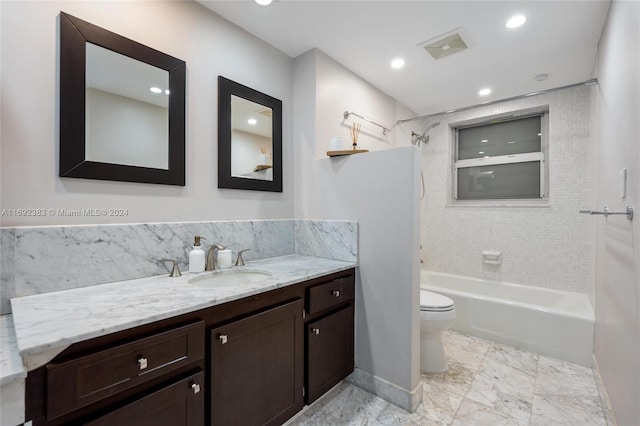 full bathroom featuring toilet, tiled shower / bath combo, and vanity