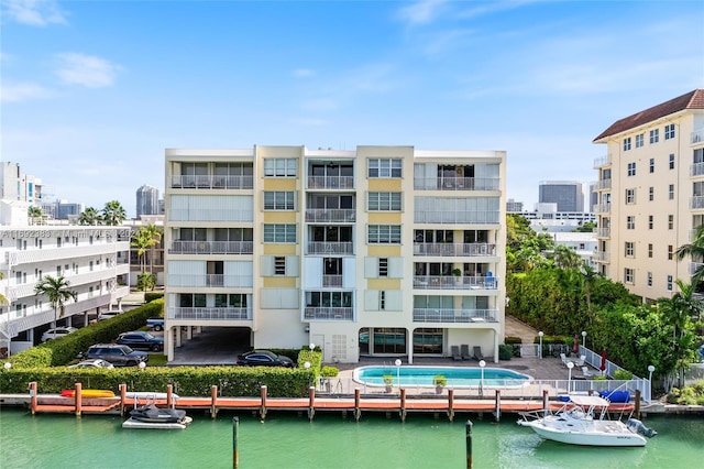 view of property with a water view and a community pool