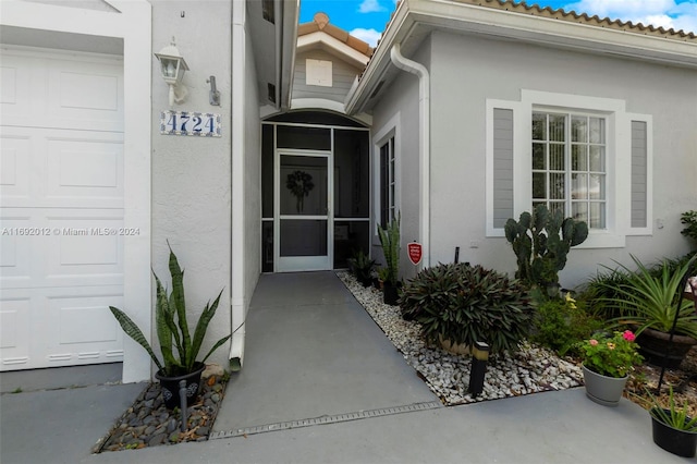 view of exterior entry with a garage