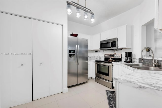 kitchen with stainless steel appliances, white cabinetry, sink, a textured ceiling, and pendant lighting