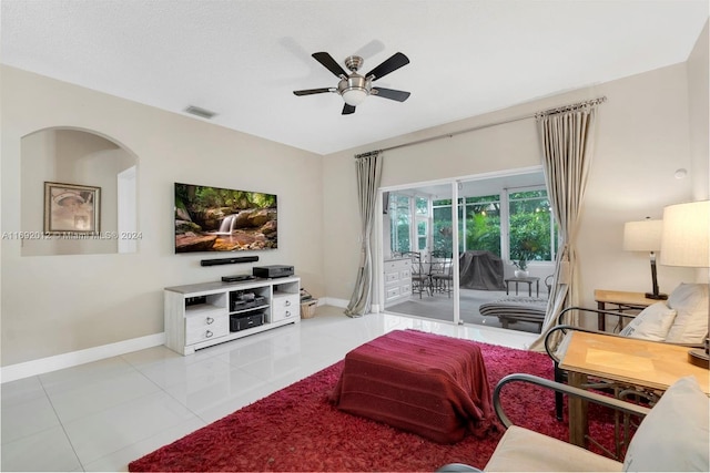 living room featuring light tile patterned flooring and ceiling fan