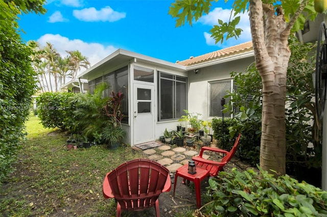 exterior space featuring a sunroom and a patio area