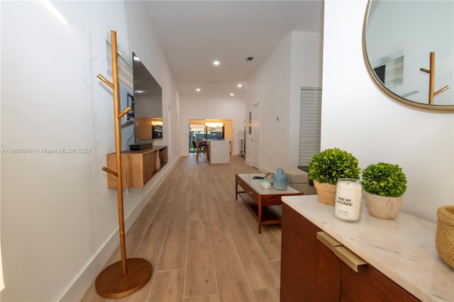 corridor with light hardwood / wood-style floors