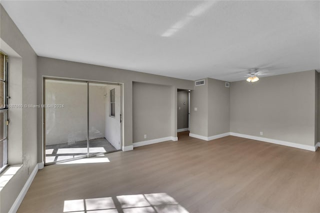 interior space with light hardwood / wood-style floors, ceiling fan, and a textured ceiling