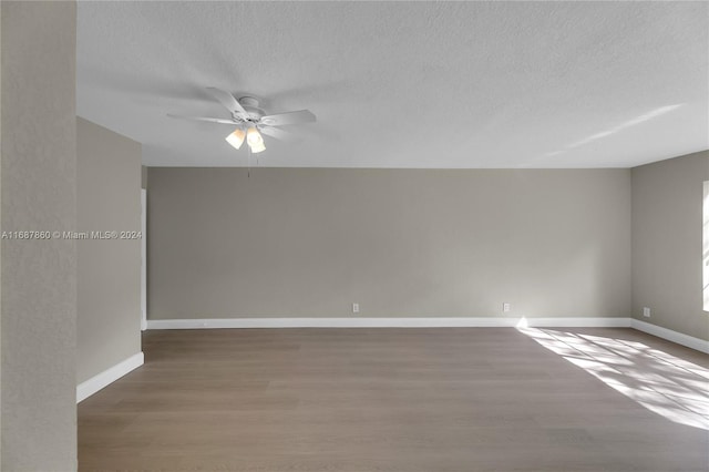 unfurnished room featuring hardwood / wood-style floors, ceiling fan, and a textured ceiling