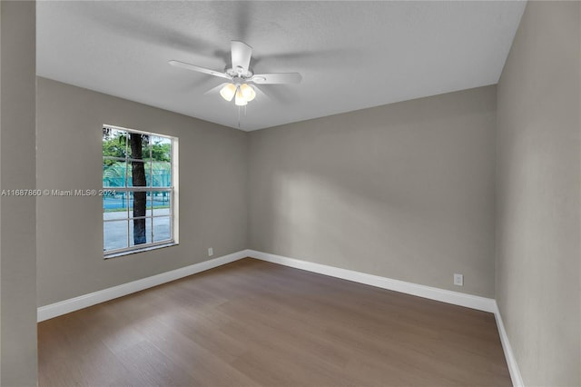 empty room with a textured ceiling, wood-type flooring, and ceiling fan