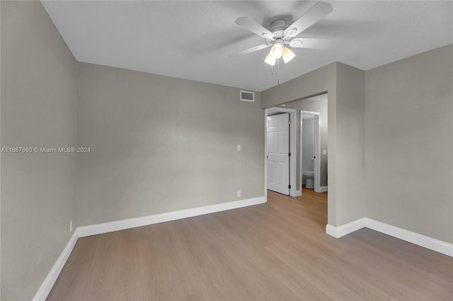 empty room with ceiling fan and light wood-type flooring