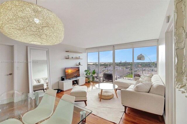 living room featuring floor to ceiling windows and hardwood / wood-style floors