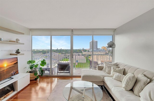 living room with hardwood / wood-style floors and expansive windows