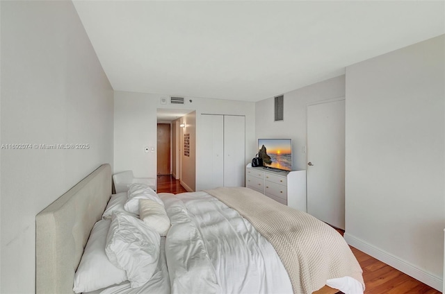 bedroom featuring light wood-type flooring and a closet