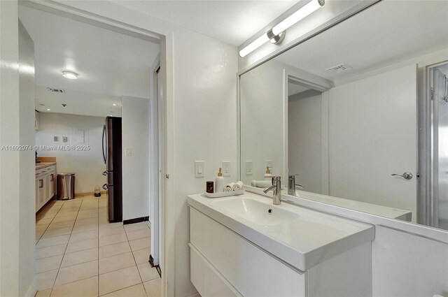 bathroom featuring tile patterned flooring and vanity