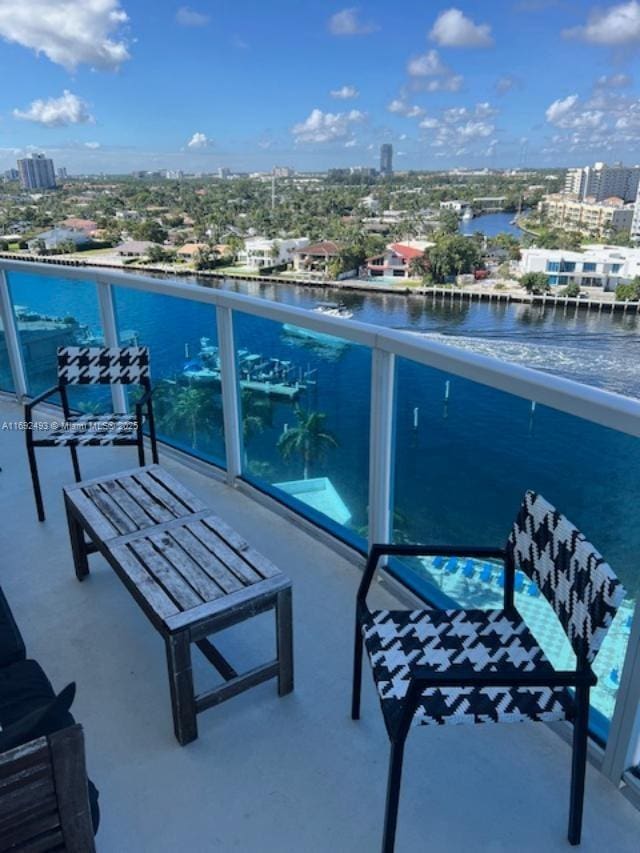 balcony with a water view and a city view