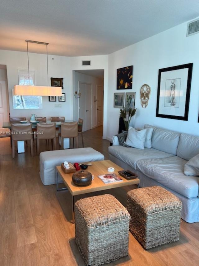 living room with light wood-type flooring and visible vents