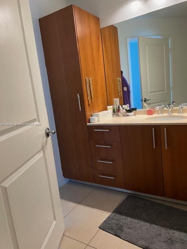 bathroom featuring tile patterned flooring and vanity