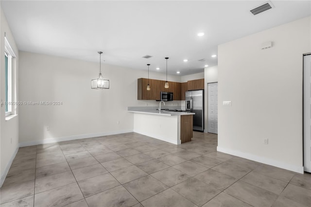 kitchen featuring kitchen peninsula, sink, light tile patterned flooring, pendant lighting, and appliances with stainless steel finishes