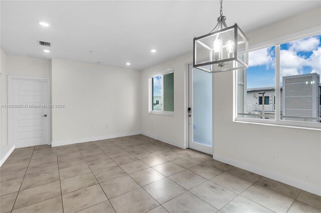 interior space featuring an inviting chandelier and light tile patterned flooring