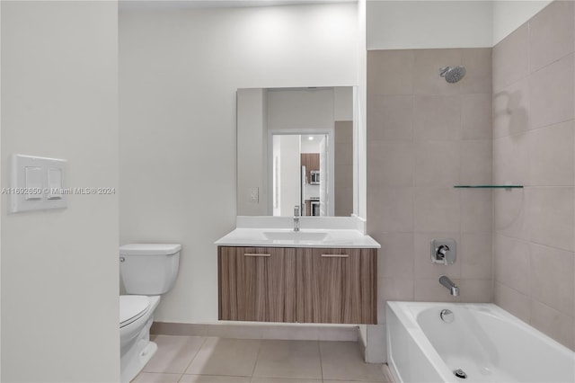 full bathroom featuring toilet, vanity, tiled shower / bath combo, and tile patterned floors