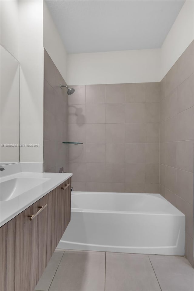 bathroom with vanity, tile patterned floors, and tiled shower / bath combo