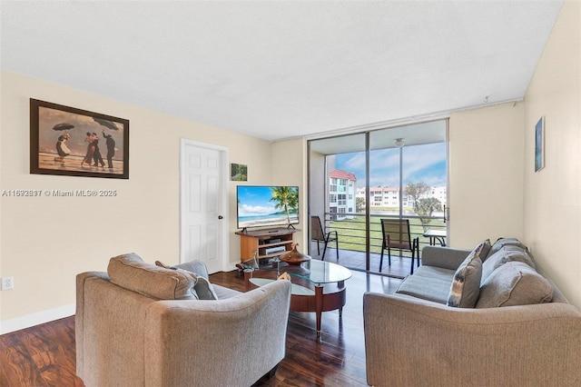 living room featuring baseboards, dark wood finished floors, and floor to ceiling windows