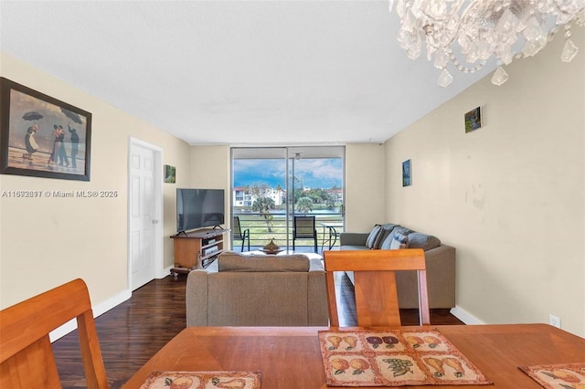 living room featuring floor to ceiling windows and dark wood-type flooring