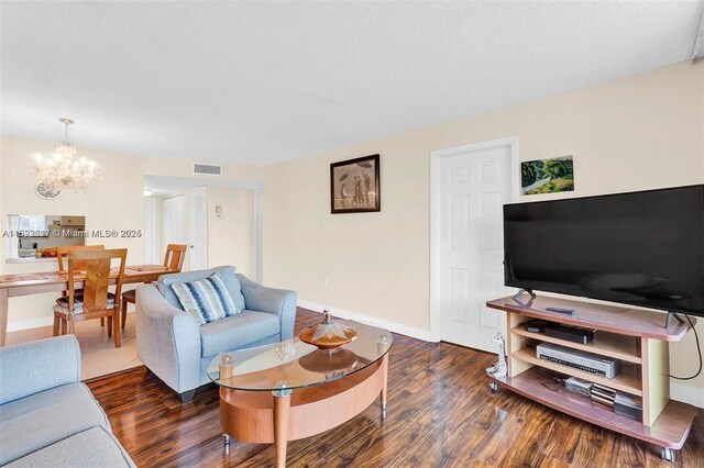 2951 E Sunrise Lakes Dr Unit 209, Sunrise, FL 33322 - living area featuring a chandelier, wood finished floors, and baseboards