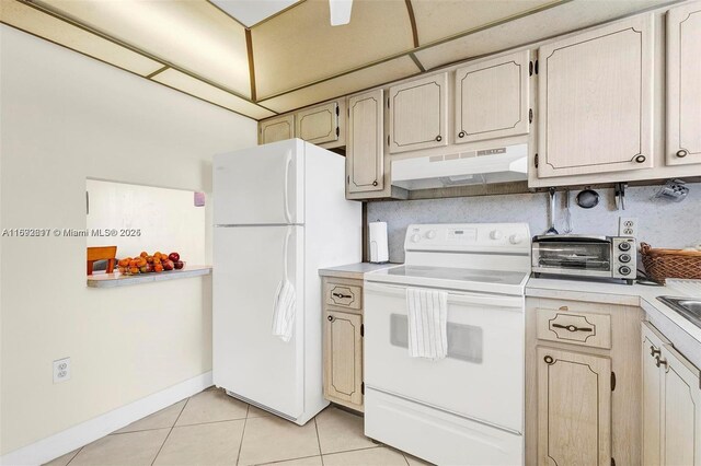 2951 E Sunrise Lakes Dr Unit 209, Sunrise, FL 33322 - kitchen with white appliances, under cabinet range hood, light countertops, and light tile patterned floors
