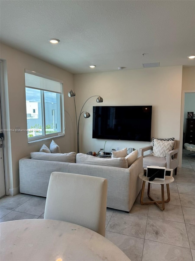 tiled living room with a textured ceiling