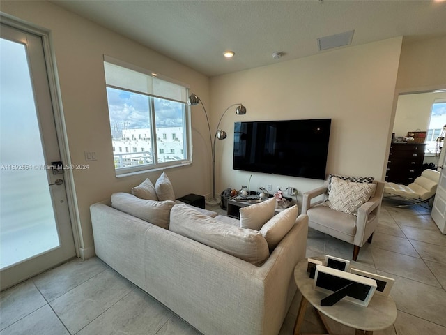 tiled living room with plenty of natural light