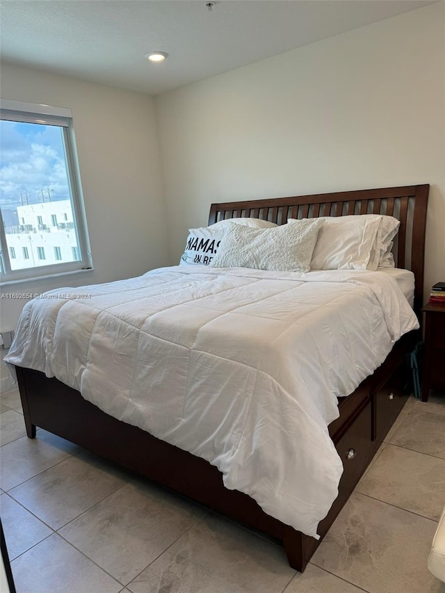 bedroom with light tile patterned floors