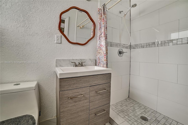 bathroom with vanity, curtained shower, and toilet