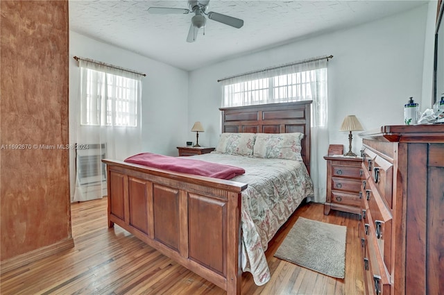 6525 Mayo St, Hollywood, FL 33023 - bedroom featuring light wood-style floors, a textured ceiling, and a ceiling fan