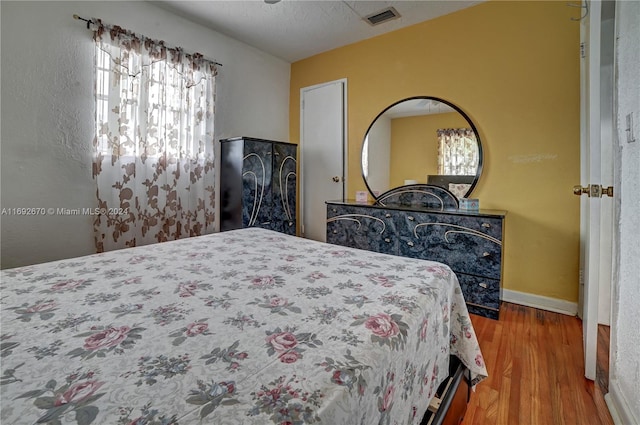 bedroom with hardwood / wood-style flooring