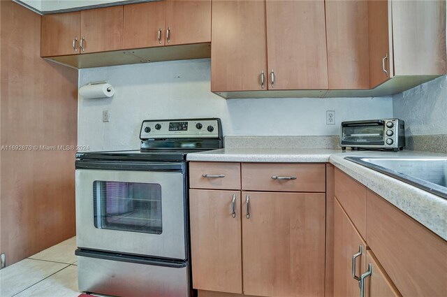 6525 Mayo St, Hollywood, FL 33023 - kitchen featuring stainless steel range with electric stovetop, light countertops, and light tile patterned floors