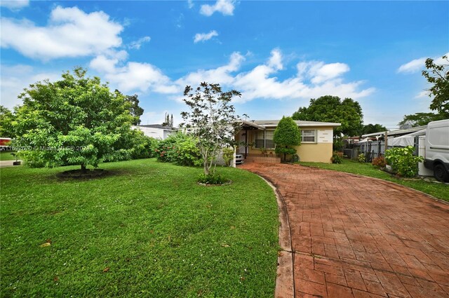 6525 Mayo St, Hollywood, FL 33023 - view of grassy yard featuring decorative driveway