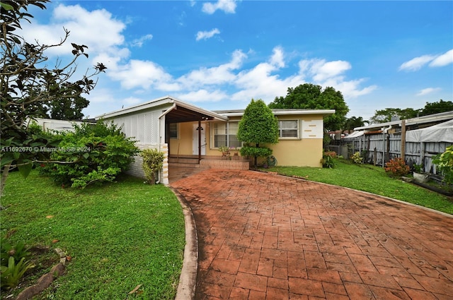 6525 Mayo St, Hollywood, FL 33023 - view of front of property with a porch and stucco siding