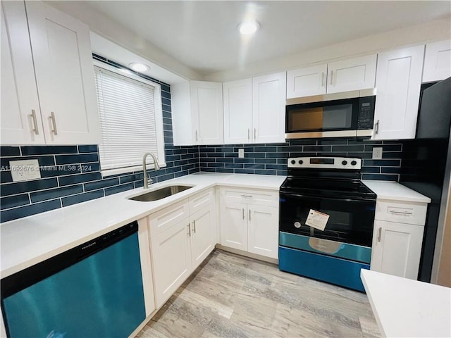 kitchen featuring white cabinetry, sink, light hardwood / wood-style floors, and stainless steel appliances