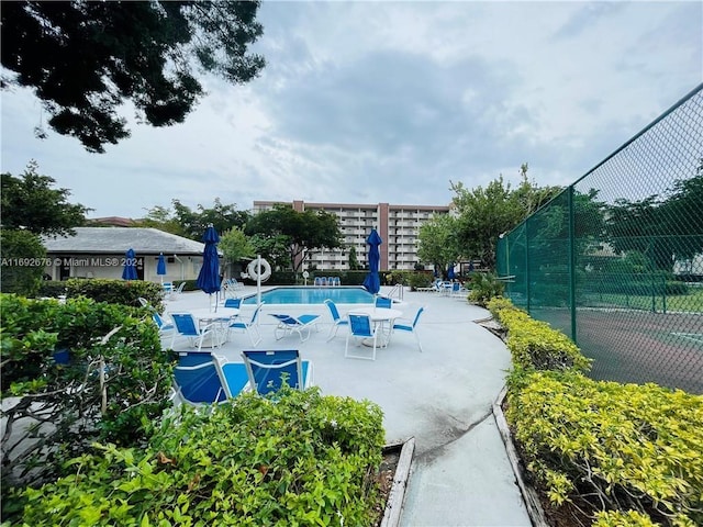 view of home's community with a swimming pool and a patio area