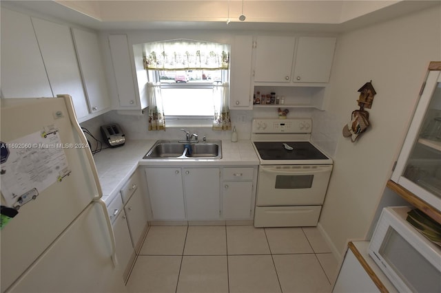 kitchen featuring white cabinetry, white appliances, sink, and light tile patterned floors